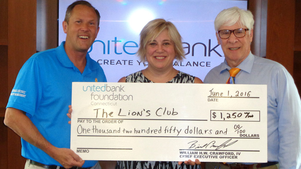 Kathy Larkin (center) from United Bank presents a check for $1,250 to Norman Juniewic and Alan Shultz from the Lion’s Club.