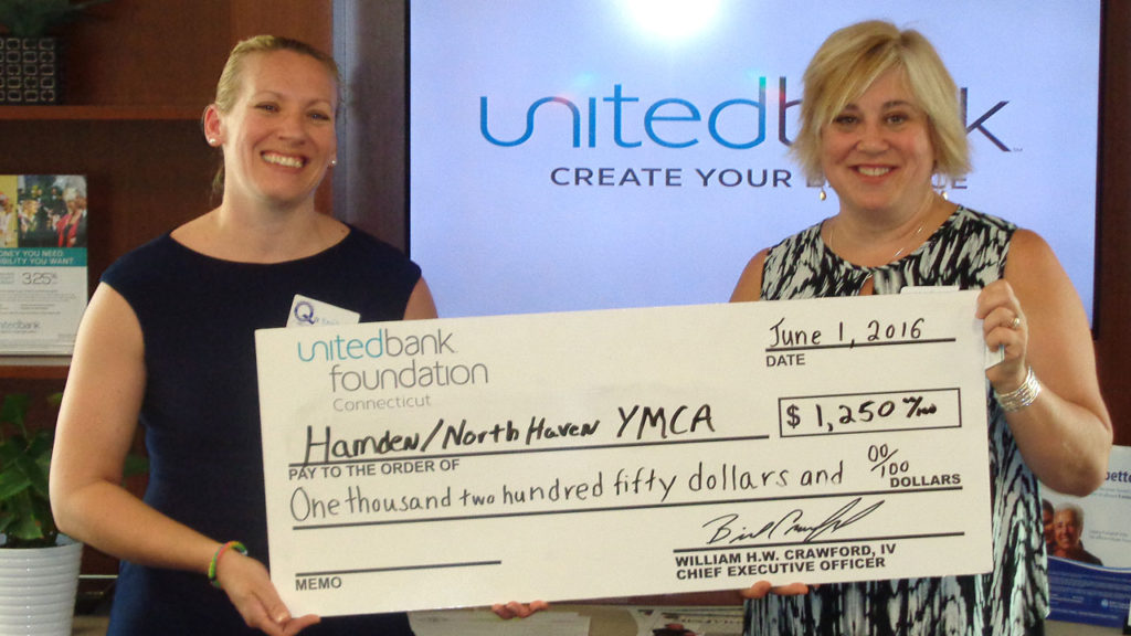 Kathy Larkin (right) from United Bank presents a check for $1,250 from the United Bank Foundation to Emily Jackson (left) of the Hamden/North Haven YMCA.