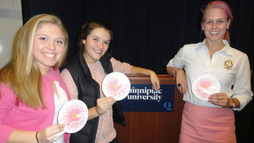 From left Quinnipiac University School of Nursing students Emily Kata, left, and Jordan LaCross, co-presidents of the Quinnipiac Student Nurses Association, and Betsy Nilan. president of the "Get in Touch Foundation" discuss the Daisy Wheel, which helps to teach girls in grades five-12 about the importance of and techniques for conducting breast self-exams.